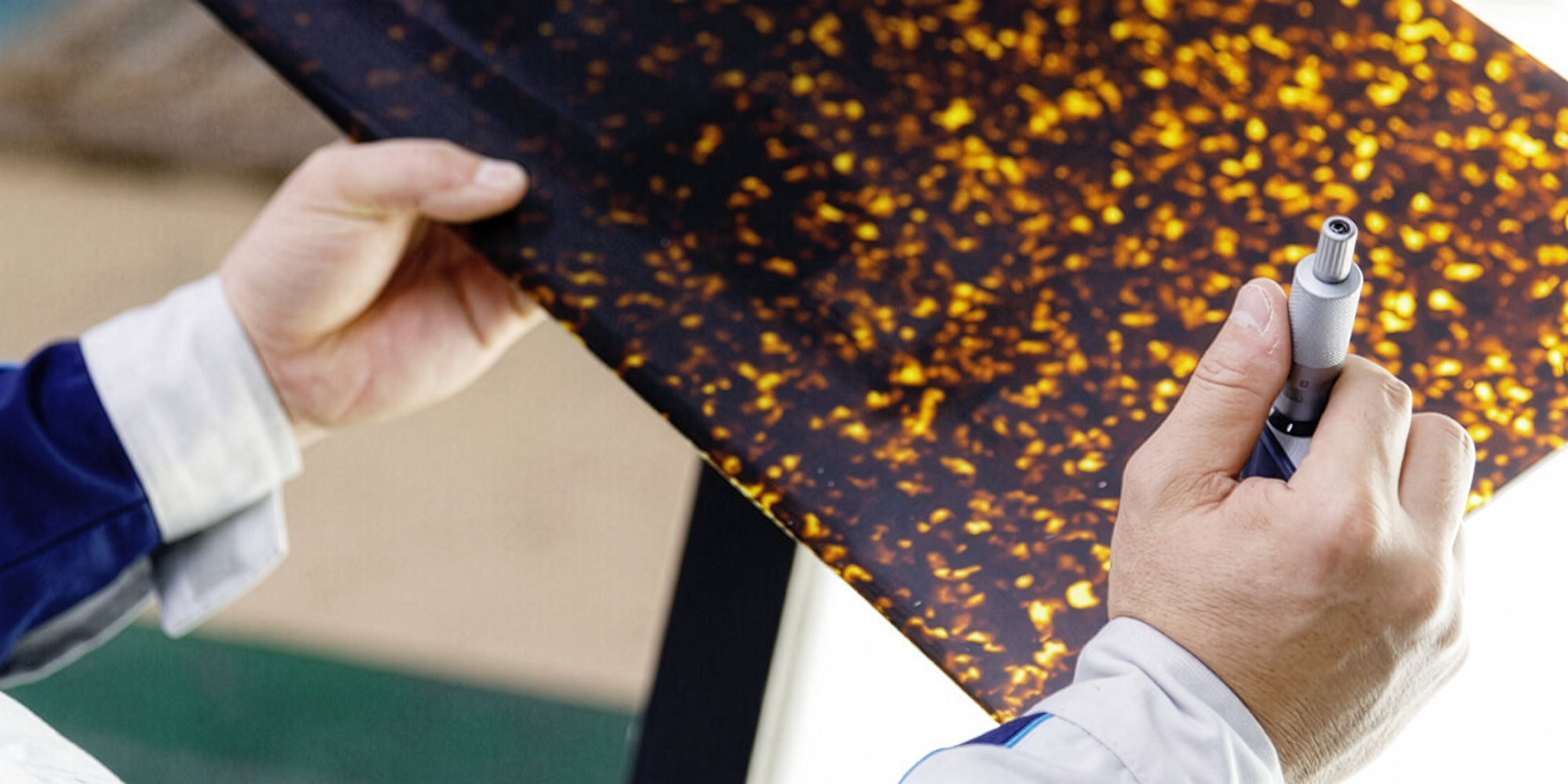 A Takiron Rowland specialist inspecting a sheet of patterned Japanese acetate